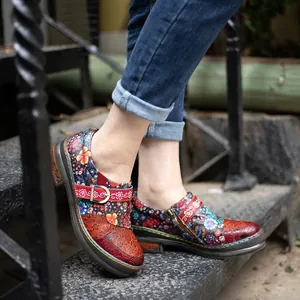 Detailed view of women's retro leather flat shoes with colorful ethnic floral patterns