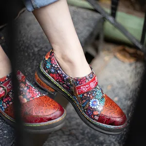 Detail of ethnic floral leather flat shoes with hand-rubbed finish and side zipper
