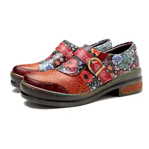 Close-up view of vintage ethnic leather flat shoes featuring vibrant floral patterns