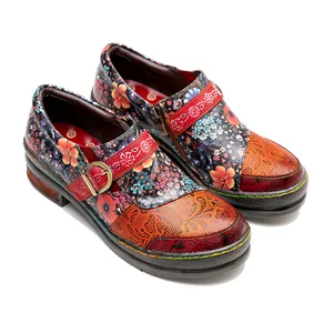 Close-up detail of colorful vintage floral leather shoes with intricate embossed patterns