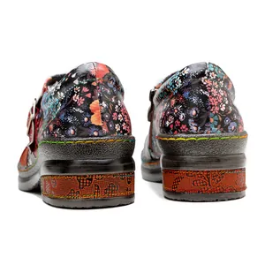 Close-up view of the heel and colorful stitching on ethnic floral leather shoes