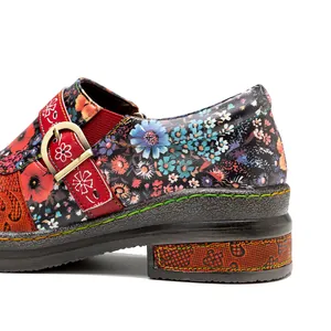 Detailed side view of vintage floral leather flat shoe with red buckle strap detail