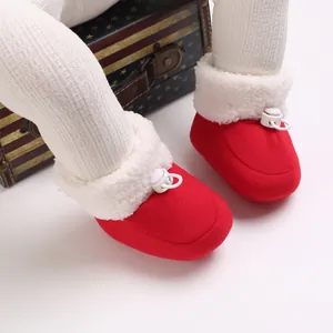 Bottines d'hiver rouges pour bébé avec doublure en fausse fourrure blanche et cordon réglable.