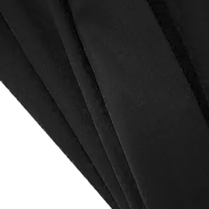 Macro view of high-quality durable black fabric texture for men's casual cropped pants