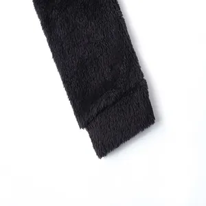 Detailed macro view showing the thick black plush fabric texture of this men's winter jacket
