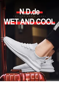 Detailed side view of men's white breathable flyknit sneakers resting on a suitcase