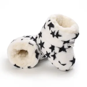 Primer plano detallado de botas de invierno para bebé con estrellas negras y forro cálido