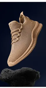 Detailed view of the breathable khaki flyknit mesh texture on men's sneakers.