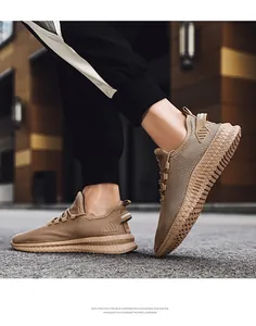 Close-up of breathable tan fly-knit men's sneakers featuring lightweight EVA foam soles