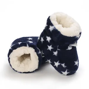 Detalle de botas de invierno para bebé con estampado de estrellas y forro de felpa suave