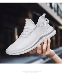 Detail view of men's white breathable fly-knit sneakers with lightweight EVA sole