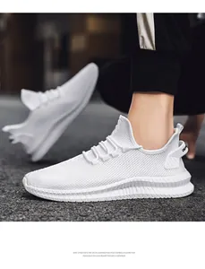 Detail view of white breathable flyknit men's sneakers with textured EVA sole