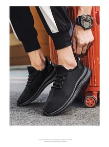 Detail of breathable black flying weave sneakers with a lightweight EVA foam sole