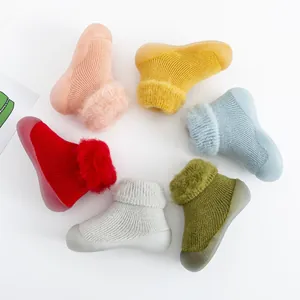 Detalle de zapatos calcetín de invierno para bebé con suela blanda y forro de felpa.