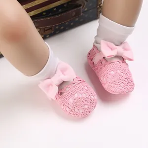 Nahaufnahme von rosa Häkelschuhen für Babys mit dekorativen Schleifen für 0-1 Jahre
