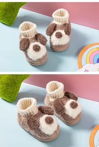 Close-up view of adorable puppy-themed fuzzy slippers for toddlers with cozy knitted cuffs.