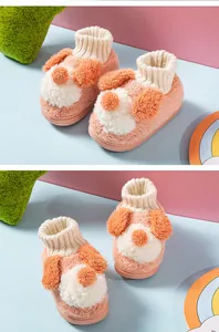 Close-up of cute puppy plush slippers with fluffy ears and knitted soft ankle collar