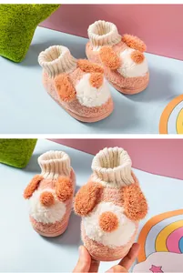 Close-up of cute puppy-themed plush slippers for children with cozy ribbed ankle cuffs