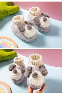 Close-up detail of cozy plush dog-themed winter slippers for toddlers and infants