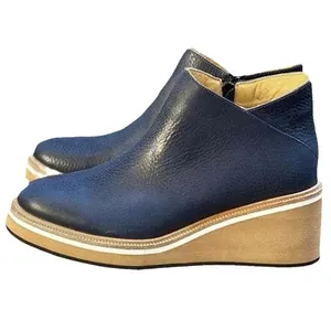 Retro dark blue pebbled leather wedge ankle boots with a side zipper and platform sole.