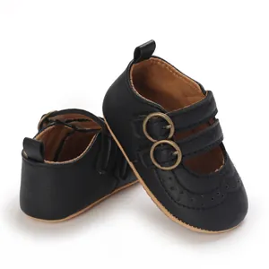 Close-up of black baby princess shoes with double buckles and soft soles.
