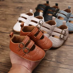 Close-up view of brown soft sole baby Mary Jane shoes with elegant brogue patterns