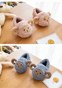 Close-up of cute cartoon sheep plush slippers for toddlers in pink and blue