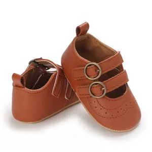 Close-up view of brown faux leather baby princess shoes with elegant double buckle straps