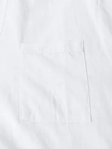 Detailed close-up showing the texture and chest pocket of a white casual cotton shirt