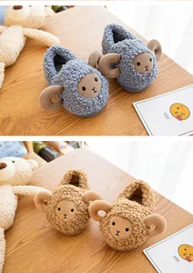 Detailed view of cute plush sheep slippers for toddlers, shown in blue and brown.