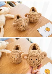 Detailed view of the soft teddy fleece texture and cute sheep design on baby slippers