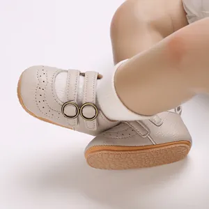 Macro shot of beige leather baby walking shoes with dual buckle and soft sole texture