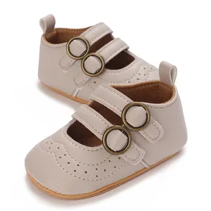 Macro view of beige soft sole baby walker shoes featuring elegant decorative perforations