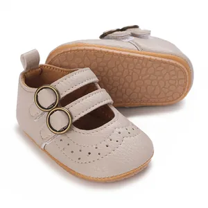Close-up of beige baby walking shoes with soft non-slip sole and buckle straps.