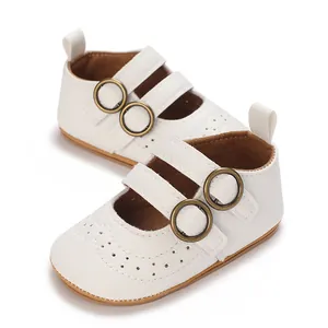 Detail view of white baby walking shoes featuring double straps and perforated toe area.