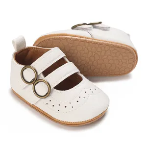 Detailed view of white baby walking shoes with soft soles and decorative buckles