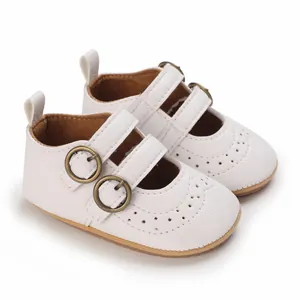Detailed macro view of white soft-sole infant princess shoes featuring elegant buckle straps.