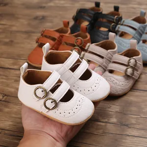Detail view of white soft sole baby princess shoes with buckle and perforated design