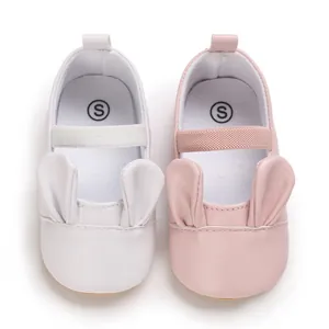 Detail of soft sole baby walking shoes with cute rabbit ears in pink and white colors
