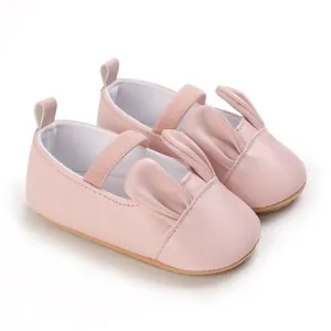 Detailed view of pink infant walker shoes with cute cartoon rabbit ears and soft soles