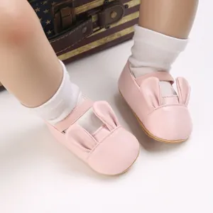Close-up of pink baby girl walking shoes with soft soles and cute bunny ear details