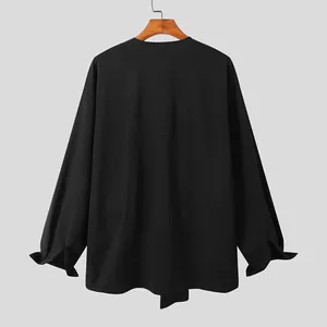 Gedetailleerd achteraanzicht van zwart herenshirt met lange mouwen en onregelmatige zoom