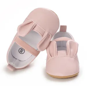 Detailed view of pink baby girl walking shoes featuring adorable rabbit ear decorations