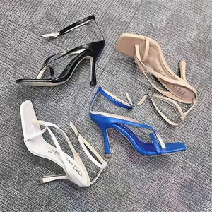 Detailed view of women's stiletto thong sandals in black, white, blue, and beige colors.