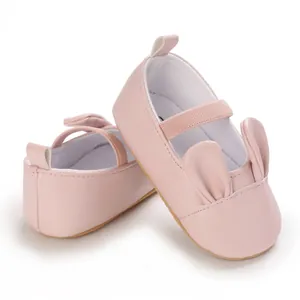 Close-up view of cute pink baby girl pre-walker shoes with 3D bunny ears details