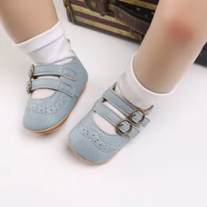 Close-up detail of light blue baby princess shoes featuring soft soles and double buckles
