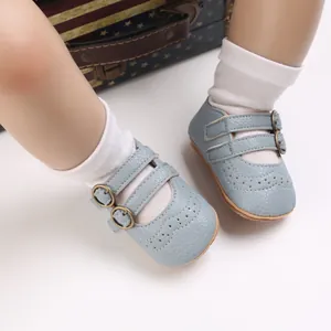 Close-up of light blue soft-soled baby princess shoes with buckle and brogue details