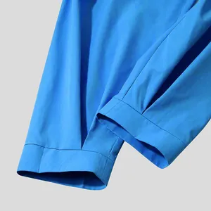 Close-up of bright blue men's casual trousers showing cuff and hem stitching detail