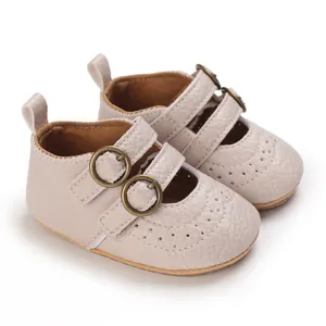 Close-up of beige baby girl Mary Jane shoes with soft sole and double buckles