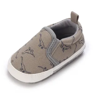 Detail view of khaki infant walking shoes with cute dinosaur prints and soft canvas